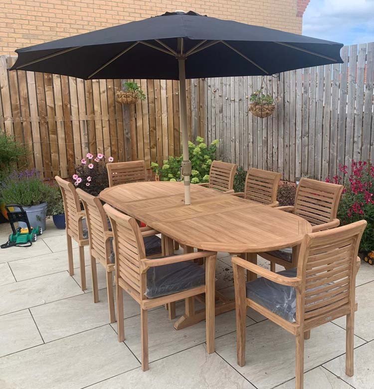 This teak garden dining set is amazing value - double extending table 1.8m to 2.4m, 8 x teak stacking chairs, free 3m parasol and cushions