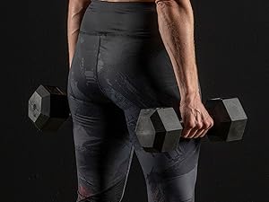 Girl holding dumbbells by side